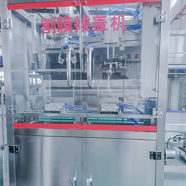 Film cutting and capping machine